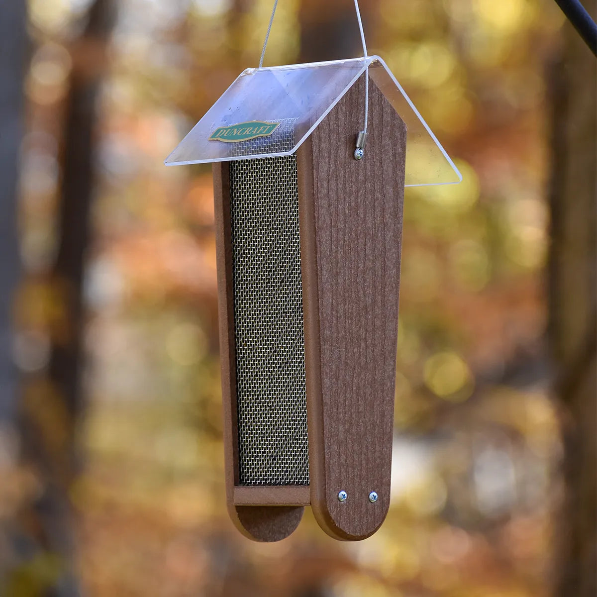Duncraft Garden Nyjer® Feeder with a clear plastic roof and wooden sides, featuring fine metal mesh for finches to feed from both sides.