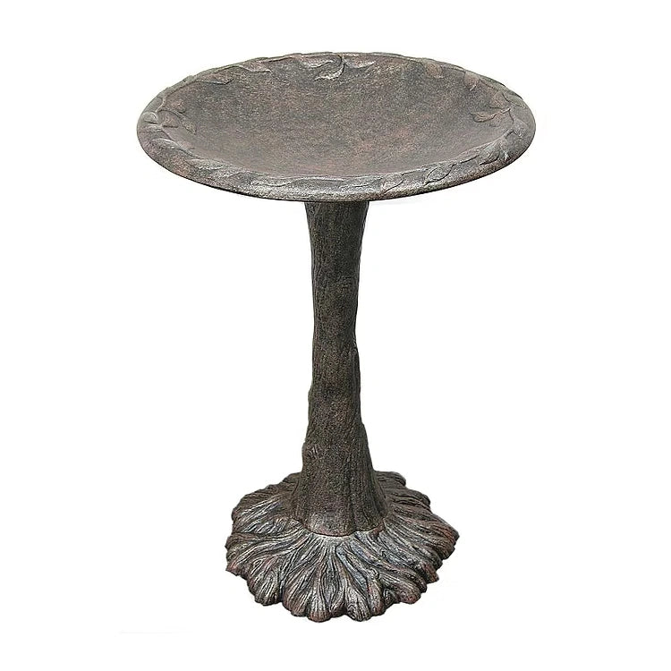 Decorative metal bird bath on a white background