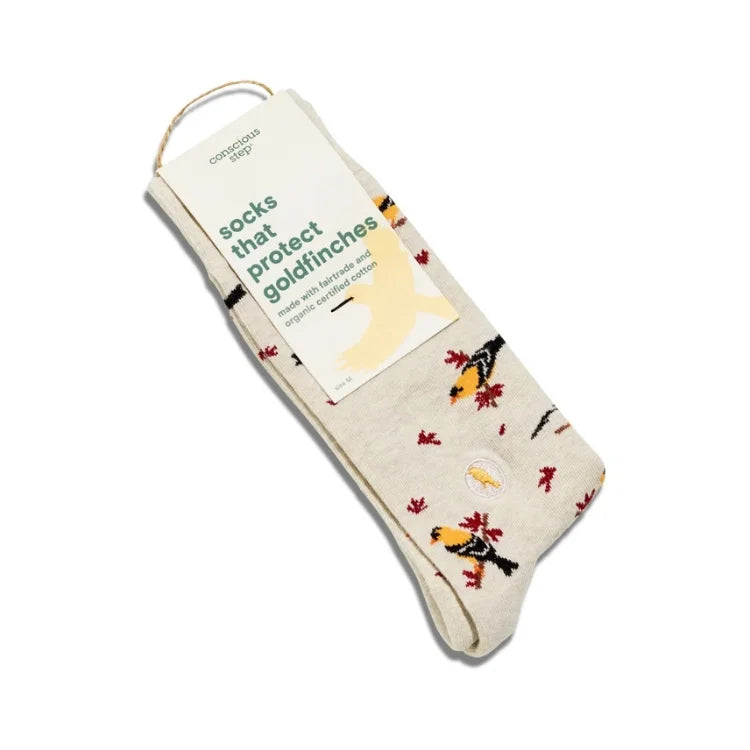 A pair of socks with a goldfinch and autumn leaf pattern, packaged with a paper tag that reads 'socks that Protect Goldfinches' and 'conscious sock'.