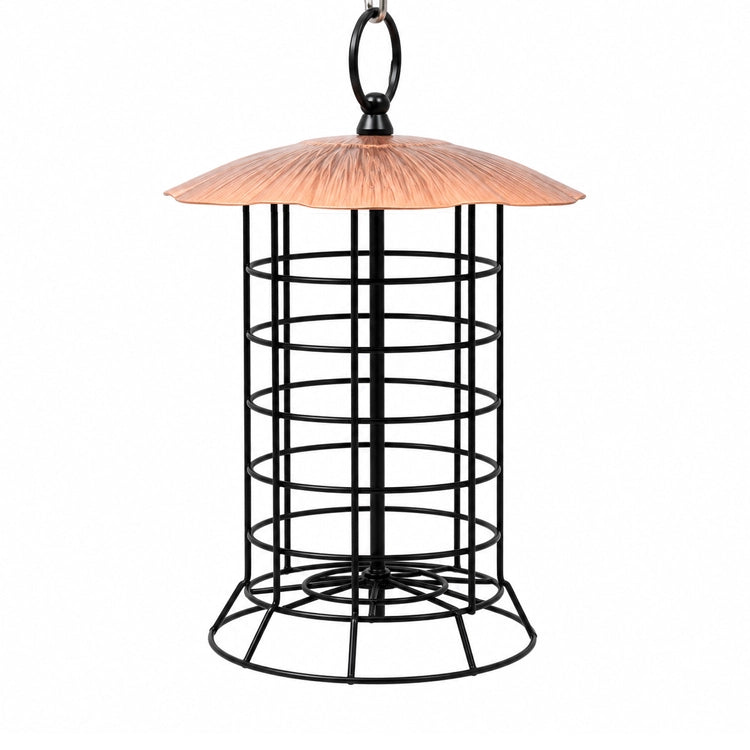 A hanging bird feeder with a black metal wire cage body, a copper-colored conical roof, and a black hanging loop at the top, shown against a plain white background.