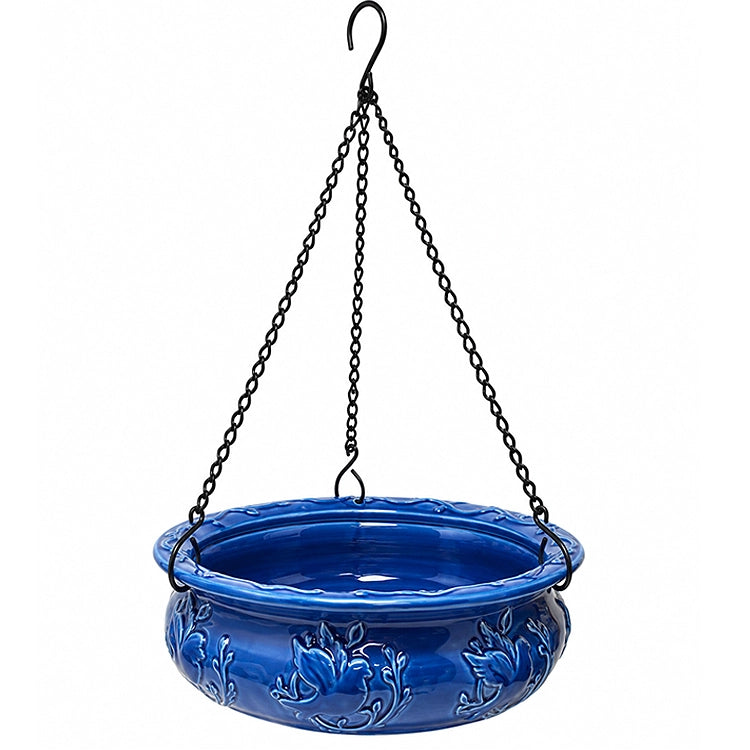 Blue glazed ceramic hanging bird feeder with decorative floral design and black metal hanging chains, ideal for serving mealworms to backyard birds.