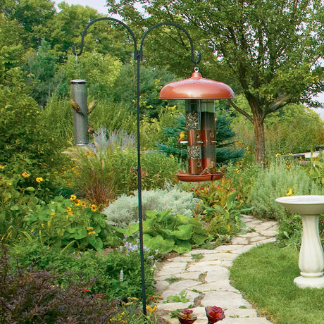 Adjustable Double Hanger in a garden, showcasing two arm hangers on a wrought iron pole designed to attract birds with stability and adjustable height.