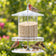 All Weather Feeder with birds perched, featuring a 10-inch diameter and 18-inch height, designed to keep seed dry and accessible in harsh weather.