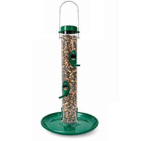Tube-style bird feeder with a clear seed reservoir, green top and base tray, and multiple feeding ports with perches, filled with mixed seed and shown on a white background.