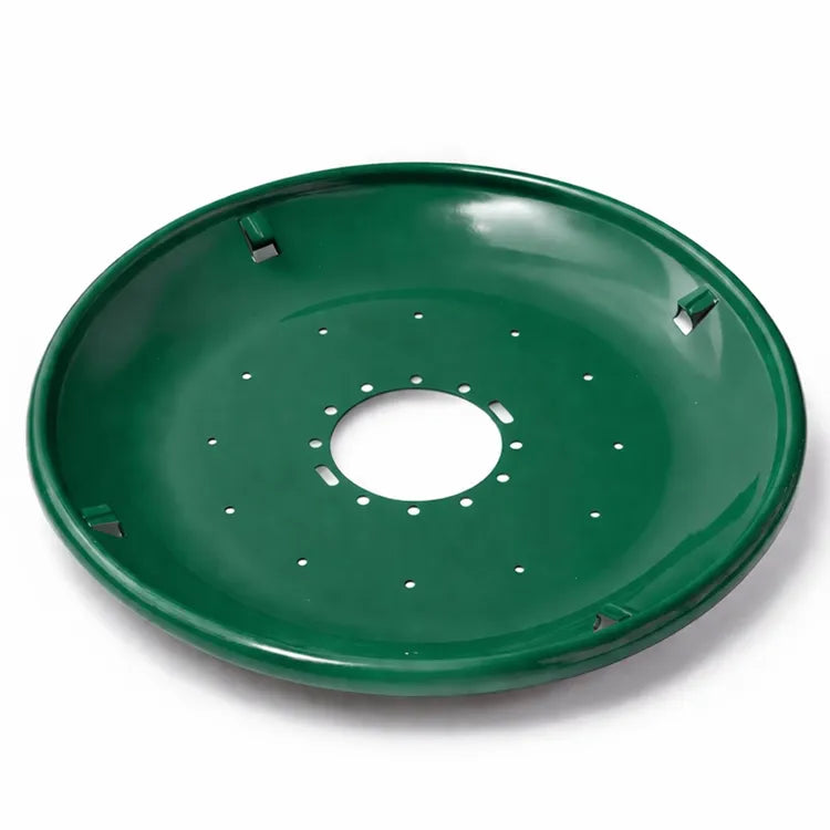 Green metal seed tray with a shallow bowl shape, central mounting hole, and multiple drainage holes, shown on a white background.