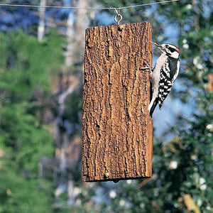Woodpecker clings to BirdsChoice Suet Sandwich Feeder, designed with bark texture for easy grip, showcasing its suitability for selective feeding.