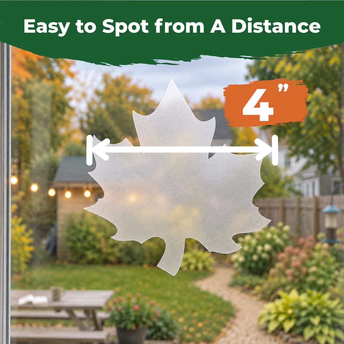 Translucent 4-inch maple leaf window decal applied to glass with a backyard visible through the window.