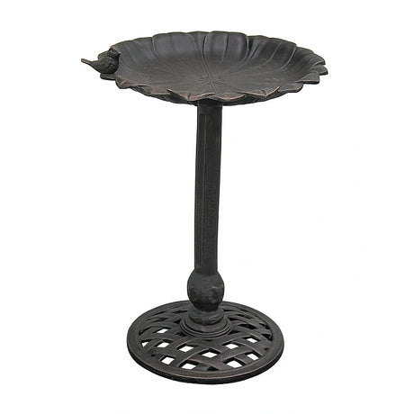 Black metal bird bath on a white background