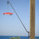 Five Position Wall Bracket with red hummingbird feeder, suspended from wooden post. Black metal arm swings 180 degrees, designed for easy filling and optimal positioning.