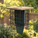 Angled view of Duncraft green recycled plastic double suet feeder with tan roof, black wire cages and built-in tail prop.
