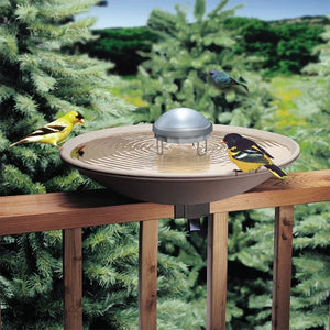 Aurora Water Wiggler in a birdbath, creating ripples to attract birds, featuring a compact design with a durable plastic dome and metal legs.