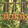 Gingerbread Men Bird Seed Treats, set of 3, hanging from a tree, made entirely of seeds, designed to attract various birds to your yard.