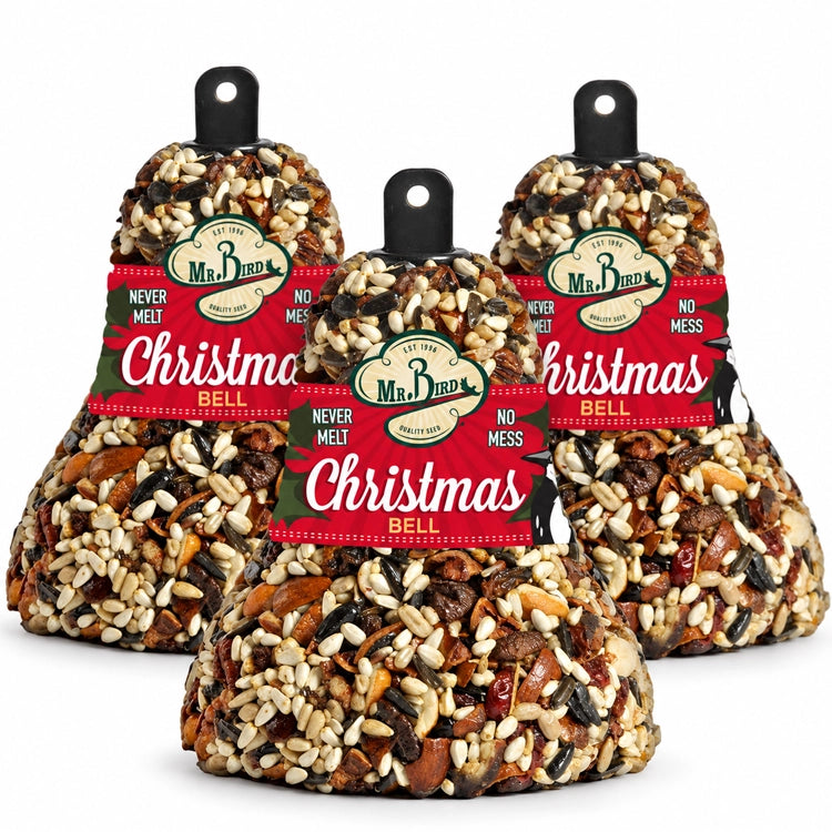 Three Mr. Bird Christmas Fruit & Nut Seed Bells with red and green labels on a white background.