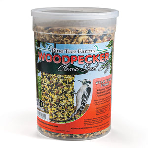 Woodpecker Seed Log, Jumbo: A clear tub containing a compressed log of mixed seeds and nuts, designed for hanging outdoors to attract woodpeckers and songbirds.