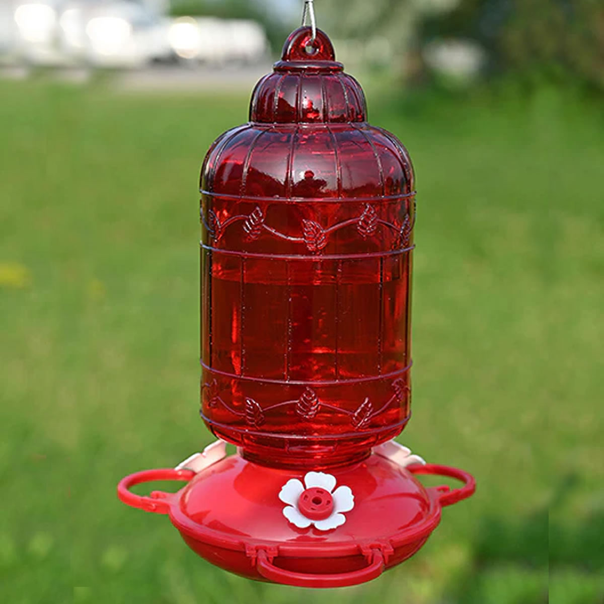Antique Bird Cage Style Glass Hummingbird Feeder with vibrant red reservoir and three flower-shaped ports, designed for easy hanging and cleaning.