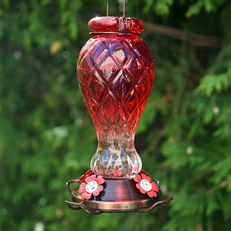 Red Jewel Glass Hummingbird Feeder with vintage red glass bottle, brushed copper base, and three flower-shaped feeding ports for multiple hummingbirds.