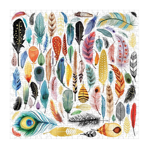 Completed Galison Feathers 500-piece jigsaw puzzle featuring colorful bird feathers, a peacock feather and gold foil details