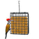 A square hanging bird feeder with a black metal grid and tan seed blocks, shown against a white background with a woodpecker perched on the left side.