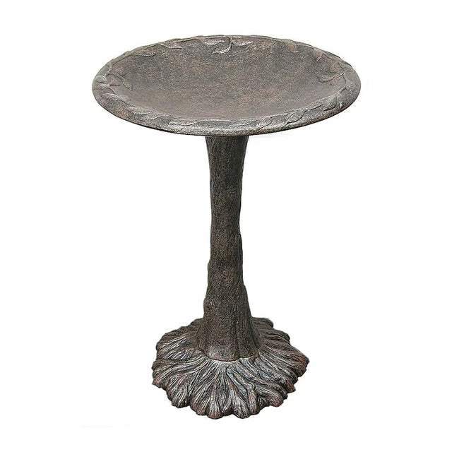 Decorative metal bird bath on a white background
