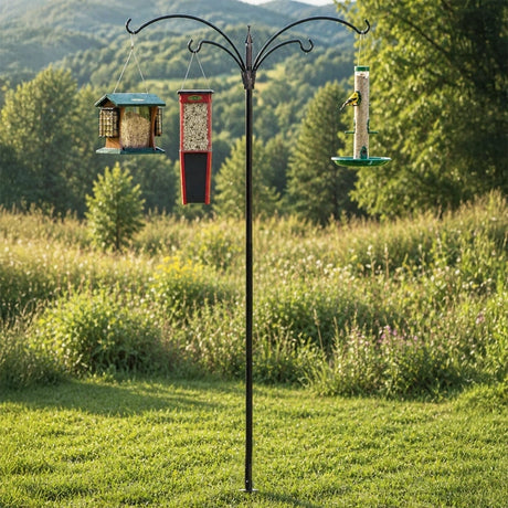 4 Arm Extended Reach Bird Feeding Station with green suet feeder, red hopper, and clear tube feeder on a sturdy metal pole in a meadow.