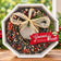 Mr. Bird Gourmet birdseed wreath with pecans and a gold bow in an octagonal gift box, displayed beside holiday greenery.