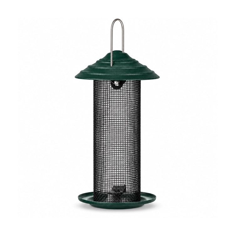 Green bird feeder with a black wire mesh tube, domed roof, and round seed tray on a white background.