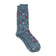 A pair of heather slate blue crew socks with a pattern of red cardinals, white snowflakes, and white pine branches, shown on a plain white background.