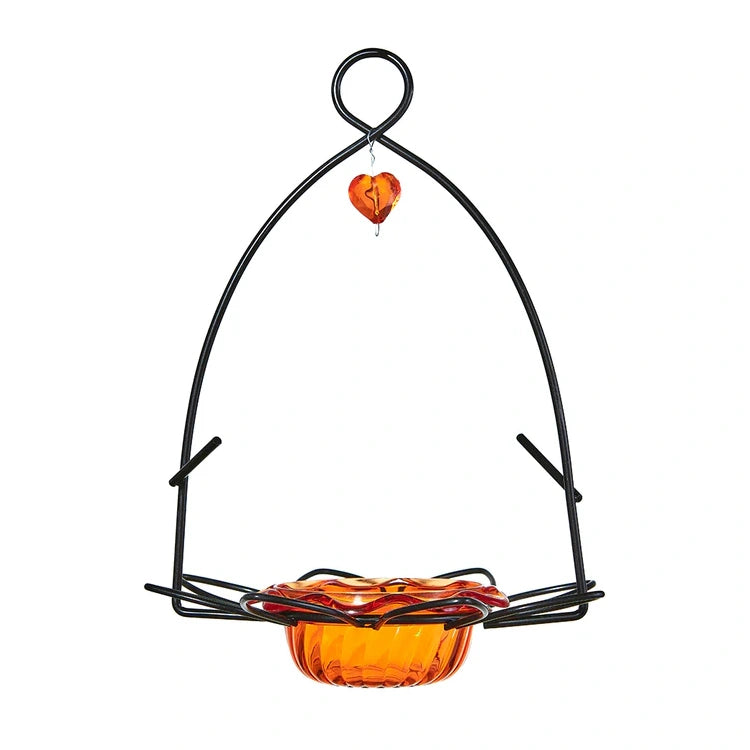Hanging bird feeder with orange bowl and heart-shaped perch on a white background