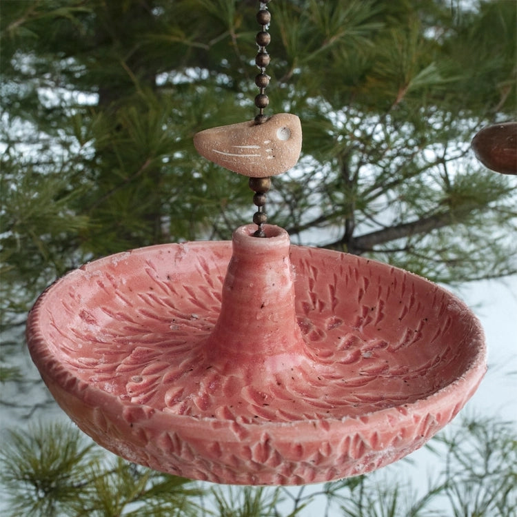 Platter Bird Feeder with circular design and rough edge, hung by brass chain, crafted from durable stoneware. Perfect for bird seed dining.