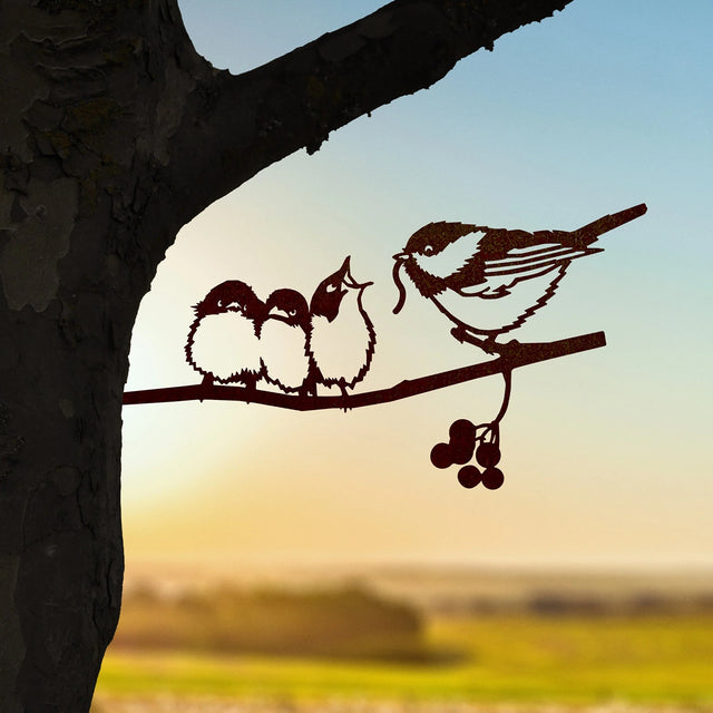 Chickadee & Chicks Regular: Metal silhouette of a mother bird feeding chicks, mounted on a tree. Durable Corten Steel enhances garden charm.