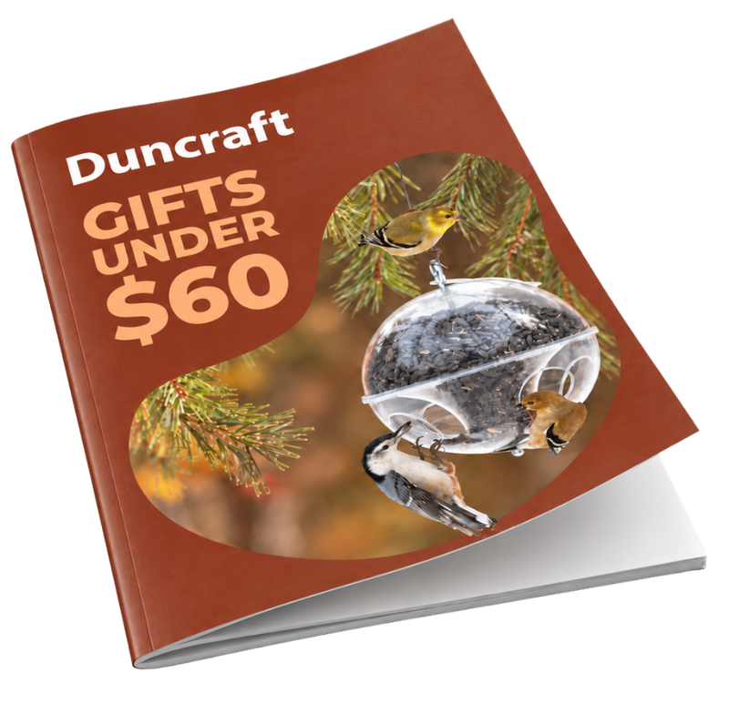A Duncraft gift card or booklet cover shown at an angle on a white background. The cover is rust-brown with the text 'Duncraft GIFTS UNDER $60' and a photo of birds around a clear seed dispenser hanging from a tree branch.