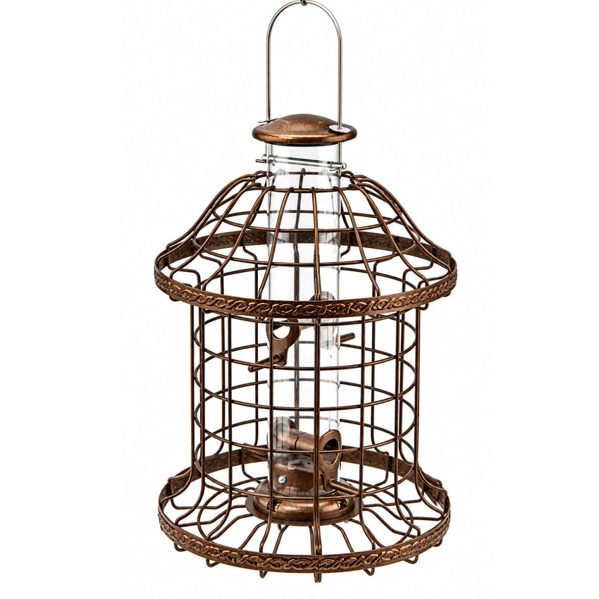 A vintage-style metal bird feeder with a copper-brown finish, featuring a clear plastic tube with ports and a hanging loop at the top, shown on a plain white background.