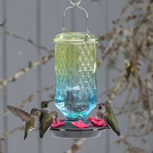 Seafoam ombre antique glass hummingbird feeder attracting hummingbirds, showcasing the decorative column design and multiple feeding stations.
